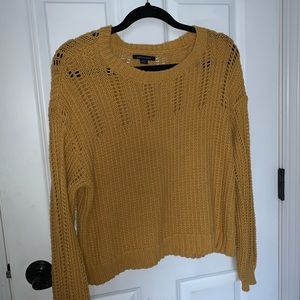Yellow/orange ish sweater.